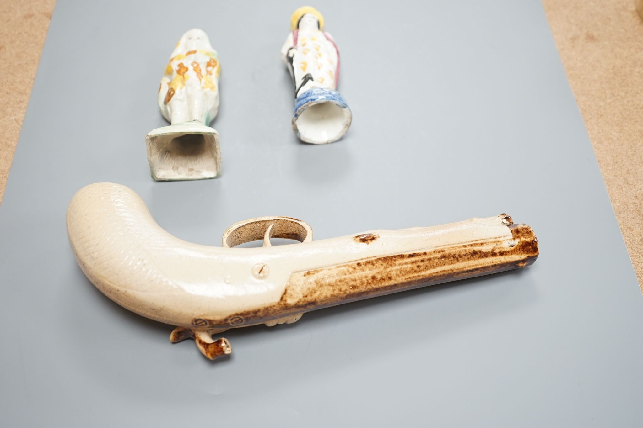 Two prattware figures circa 1800. and a salt-glazed pistol 25cm